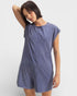 Woman wearing a blue dress against a white background