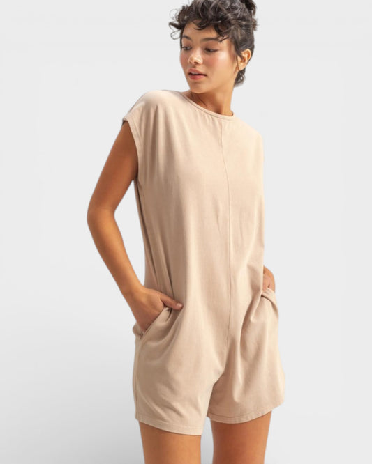 Woman wearing a beige sleeveless dress on a white background
