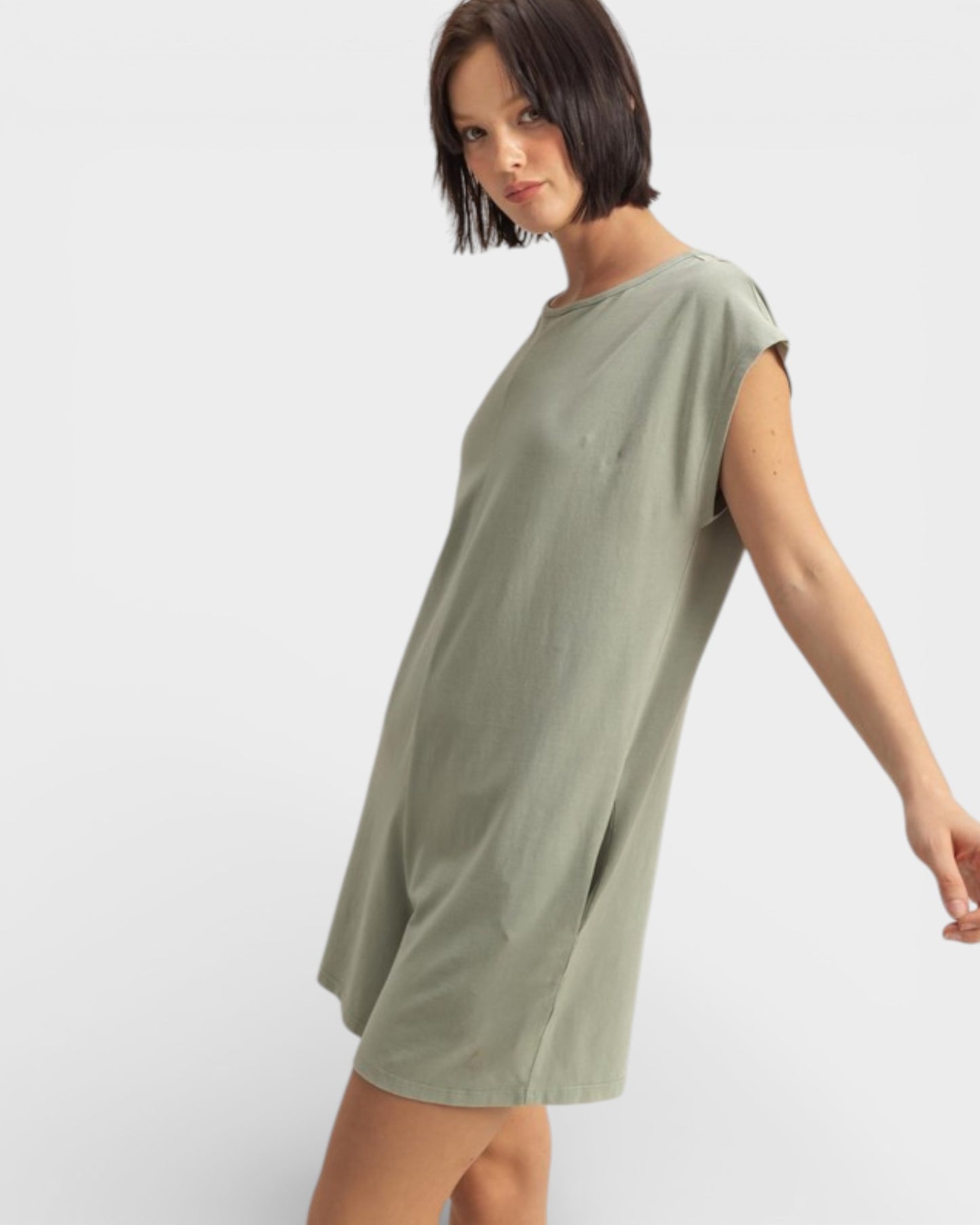 Woman wearing a green dress on a white background