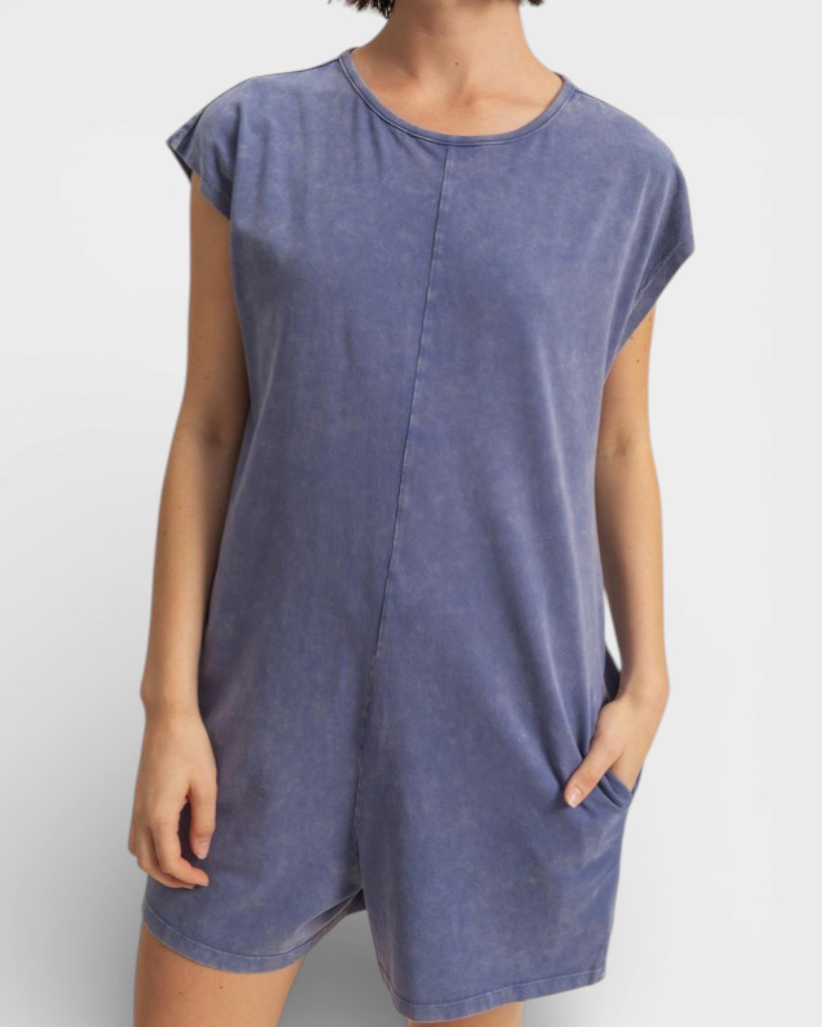 Blue sleeveless dress worn by a person on a white background