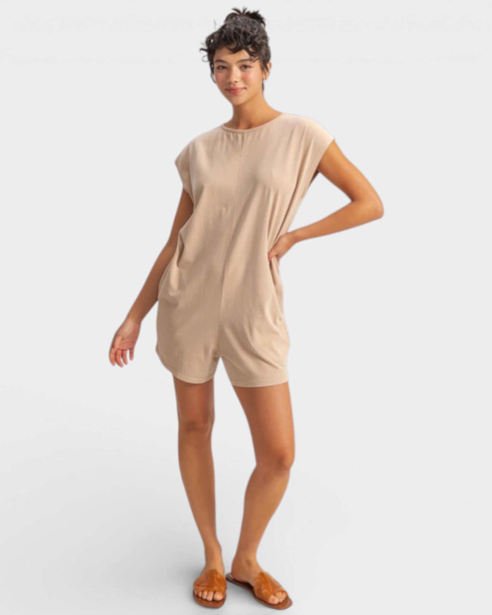 Woman wearing a beige dress on a white background