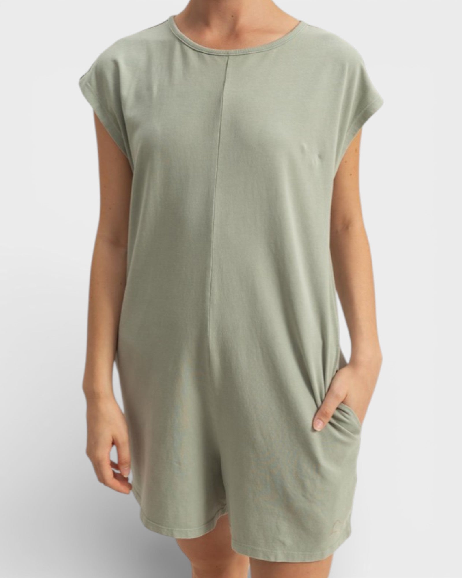Person wearing a green dress on a white background