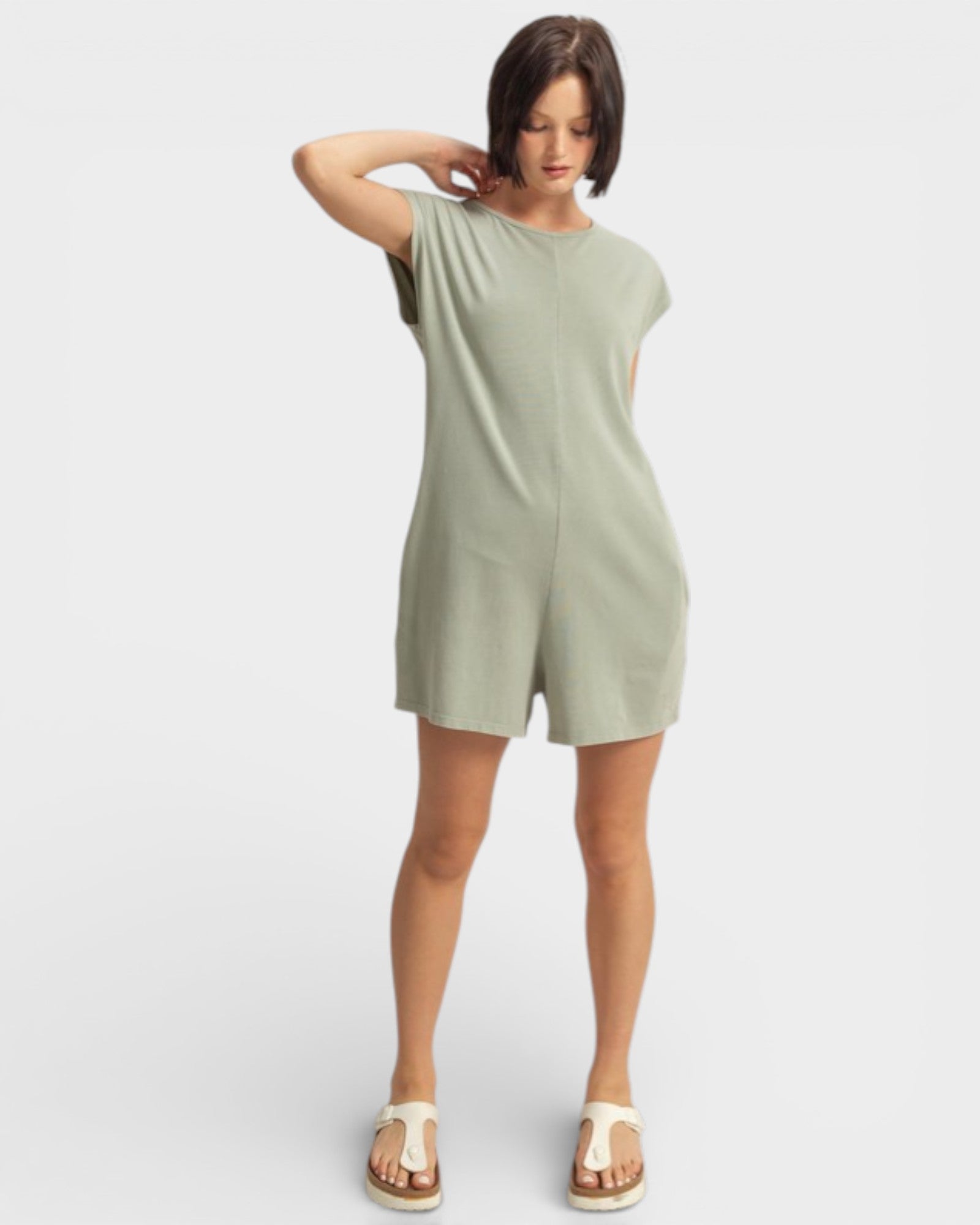 Woman wearing a green dress on a white background