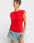 Person wearing a red sleeveless top and denim shorts on a white background