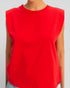 Red sleeveless top worn by a person on a plain background