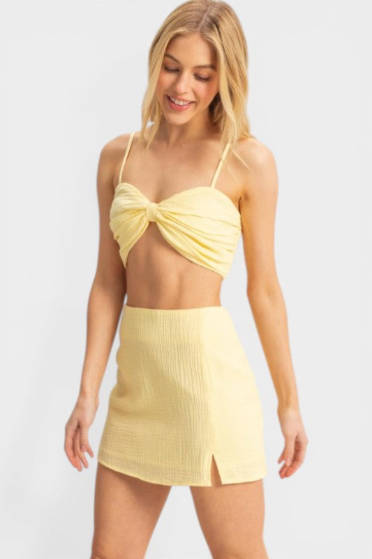 Woman wearing a yellow bikini set on a white background