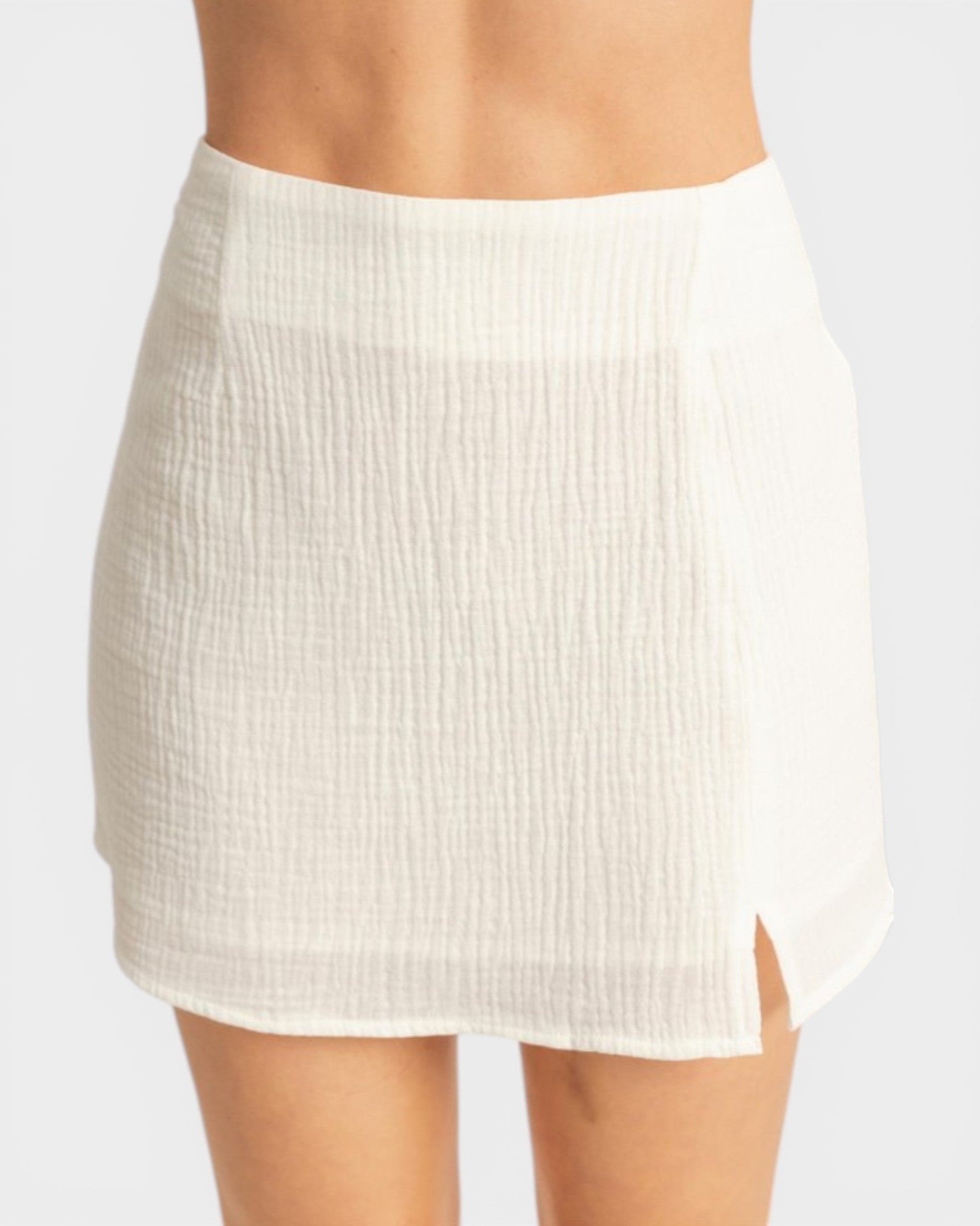 White skirt worn by a person on a white background
