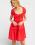 Woman wearing a red dress with puff sleeves on a white background