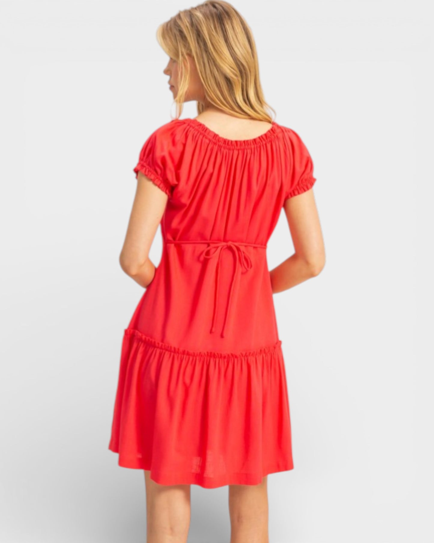 Woman wearing a red dress on a white background