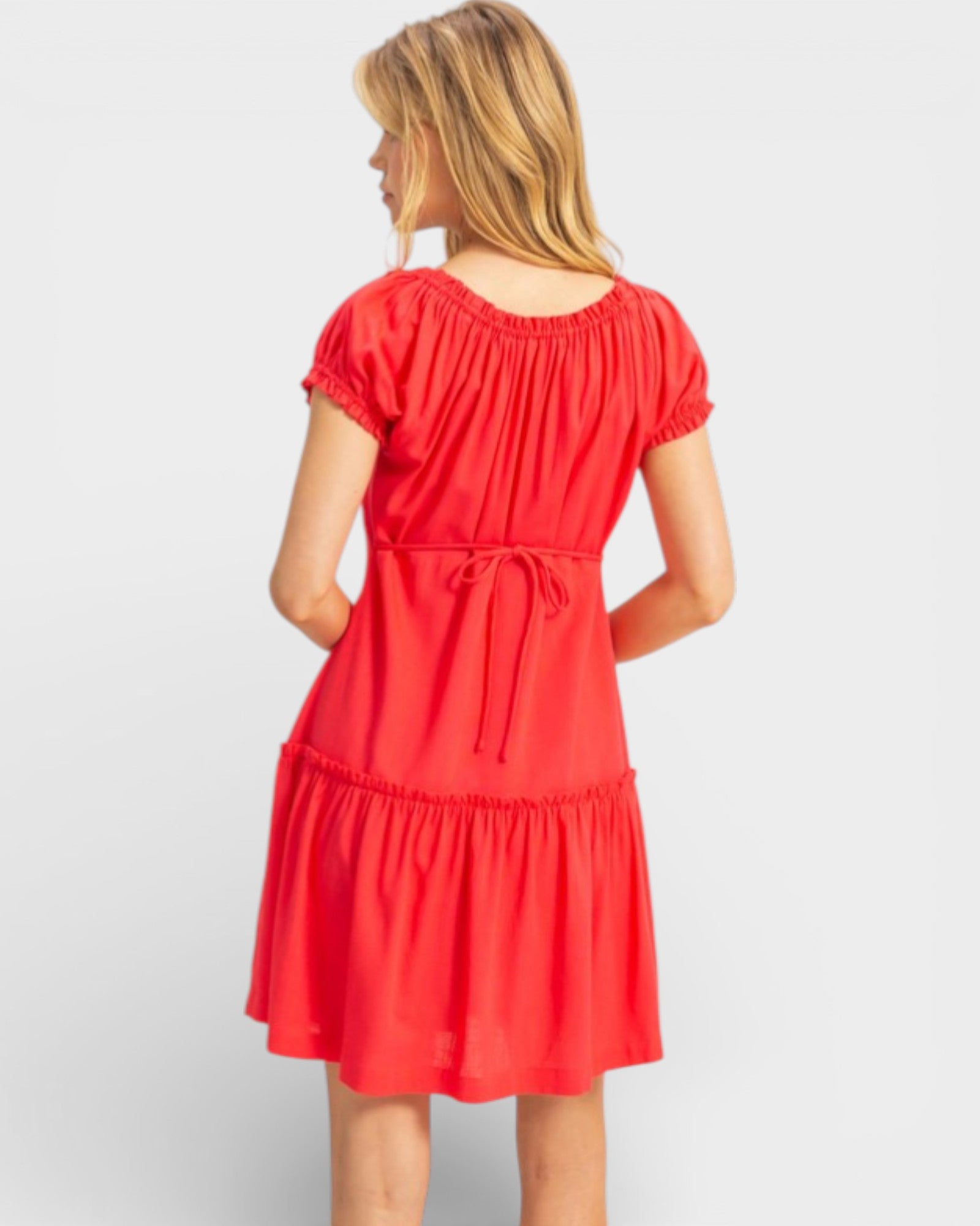 Woman wearing a red dress on a white background