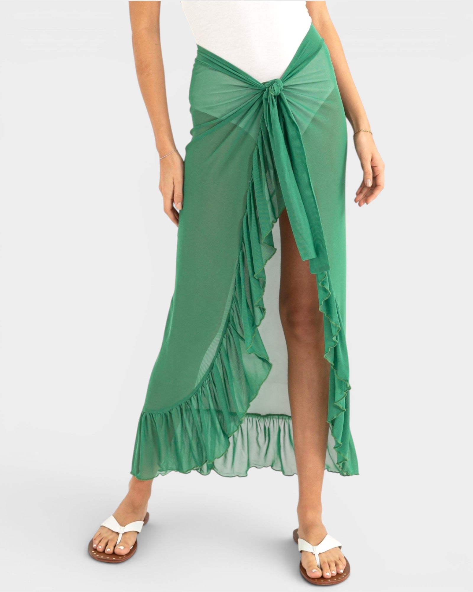Green ruffled skirt worn by a person on a white background