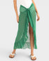 Green ruffled skirt worn by a person on a white background