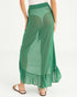 Green skirt worn by a person on a white background