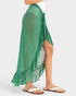 Green ruffled skirt worn by a person on a white background
