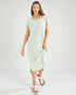 Woman wearing a light green dress on a white background