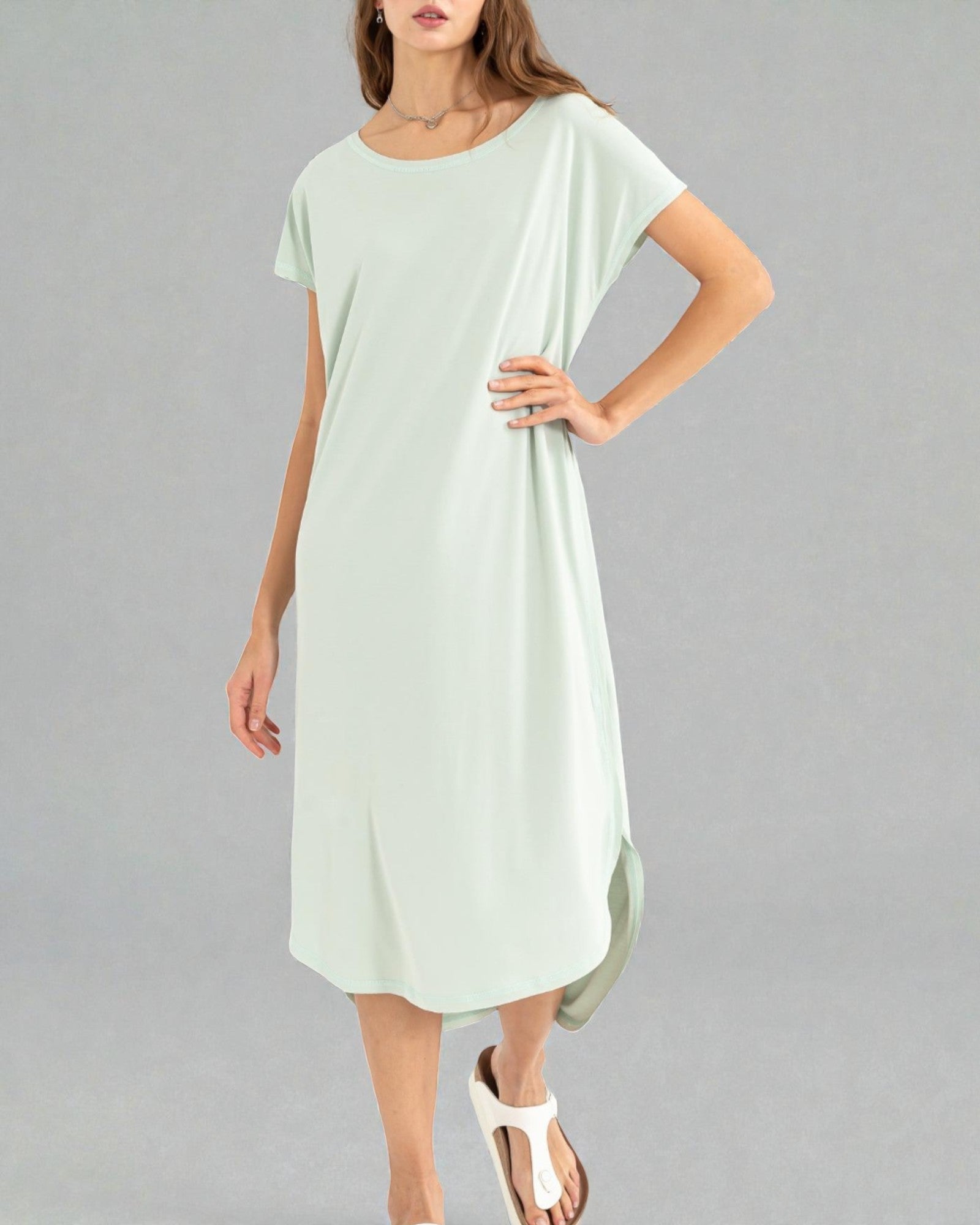 Light green dress worn by a model on a gray background