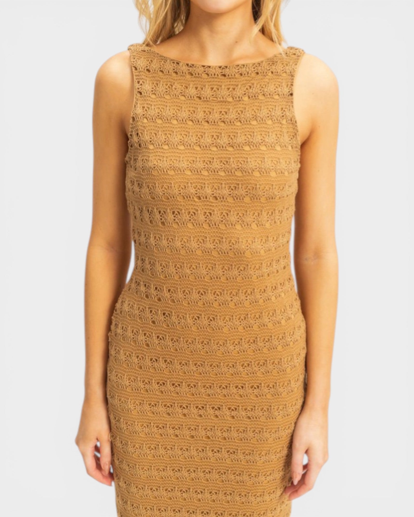 Woman wearing a patterned brown dress on a white background