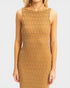 Woman wearing a patterned brown dress on a white background