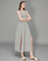 Woman wearing a light gray sleeveless dress with a slit on a gray background