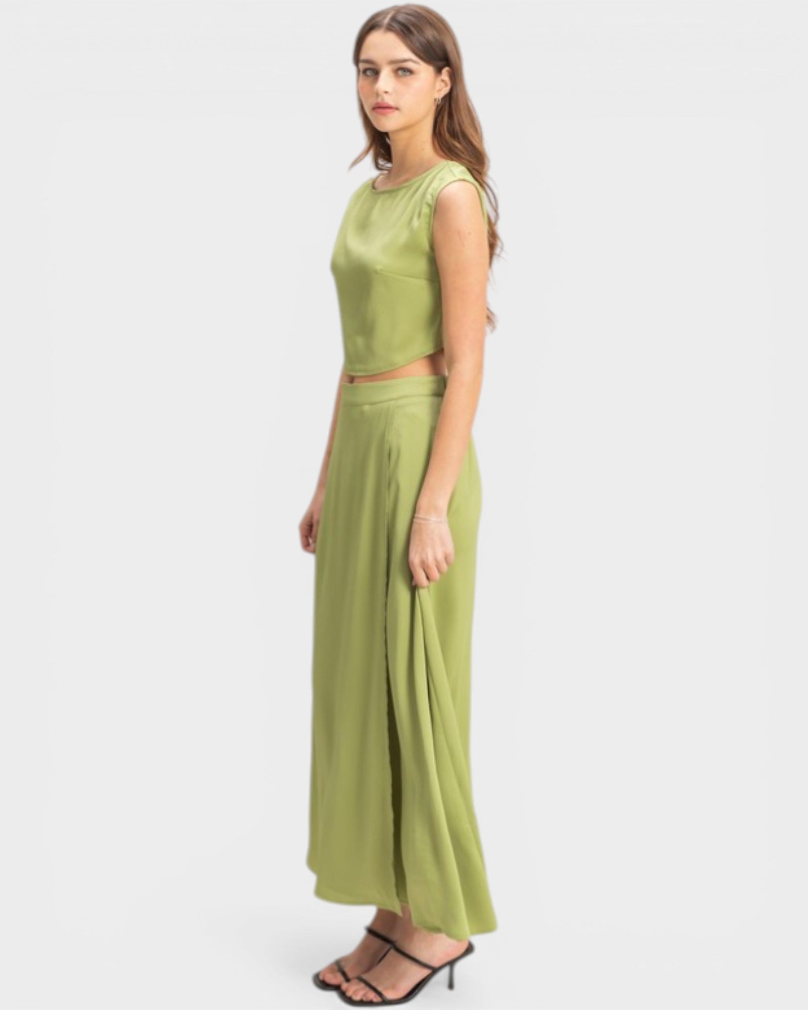 Woman wearing a green dress on a white background