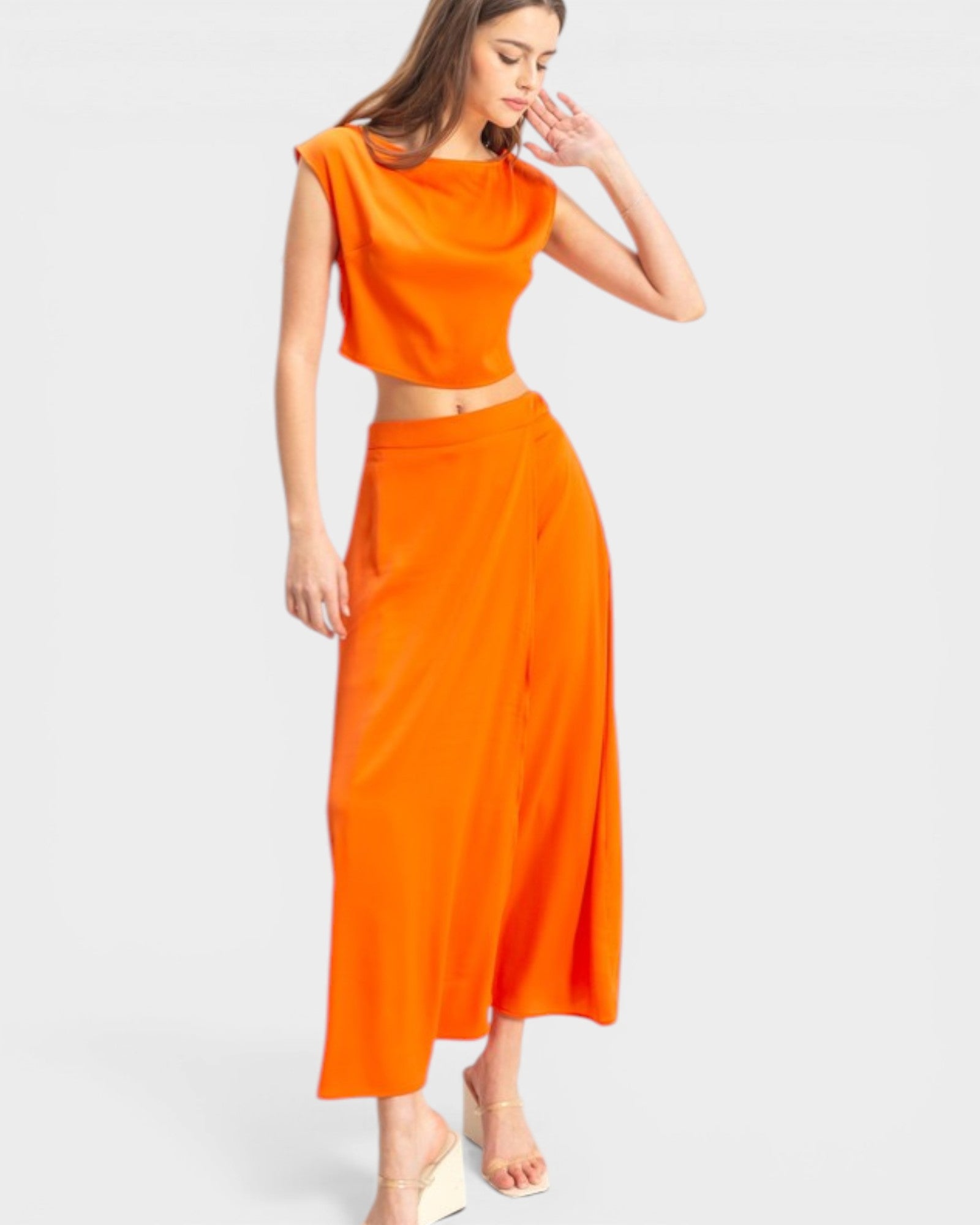 Woman wearing an orange outfit on a white background