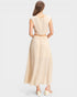 Woman wearing a beige dress on a light gray background