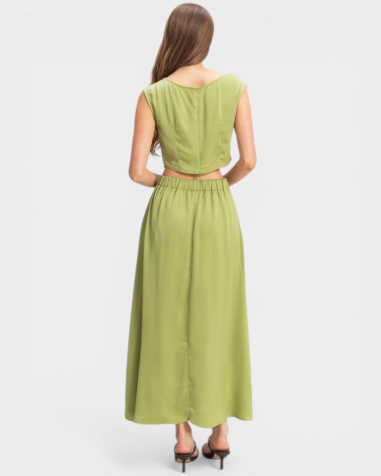 Woman wearing a green dress on a white background