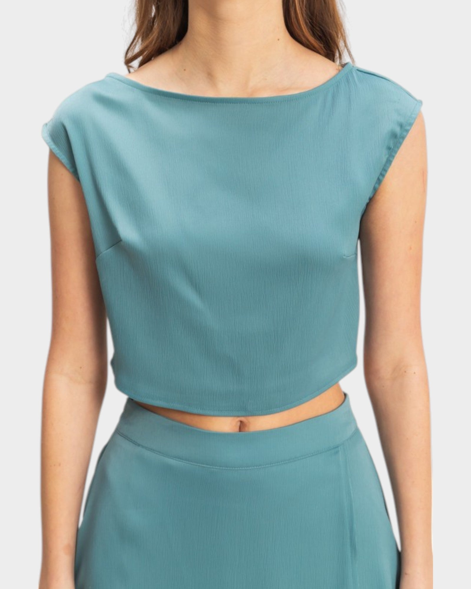 Teal two-piece outfit on a plain background