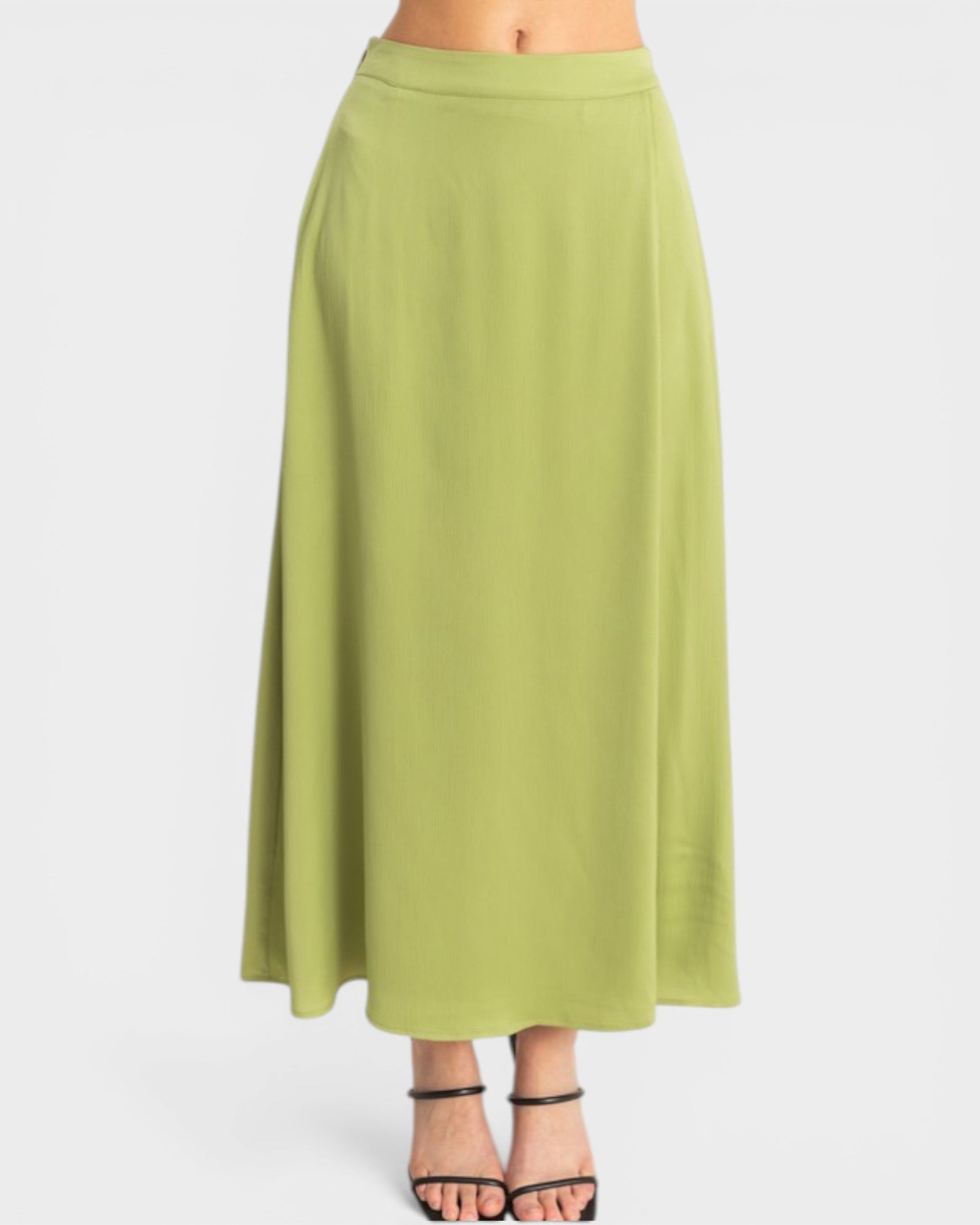 Green skirt worn by a person on a white background