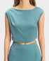 Teal two-piece outfit on a plain background