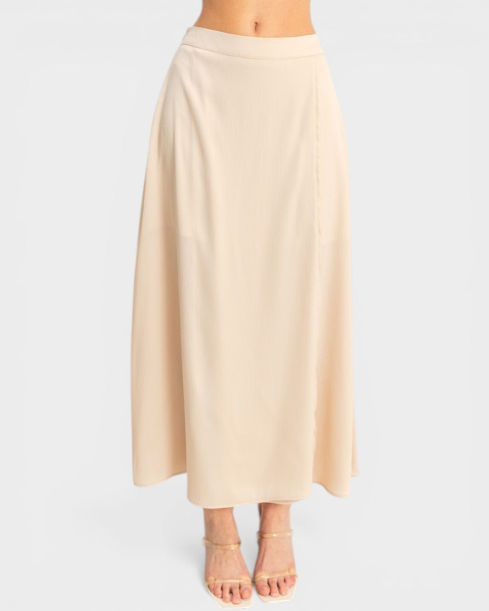 Beige skirt worn by a person on a white background