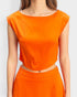 Orange top worn by a person on a white background