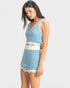 Woman wearing a blue and white striped dress on a plain background
