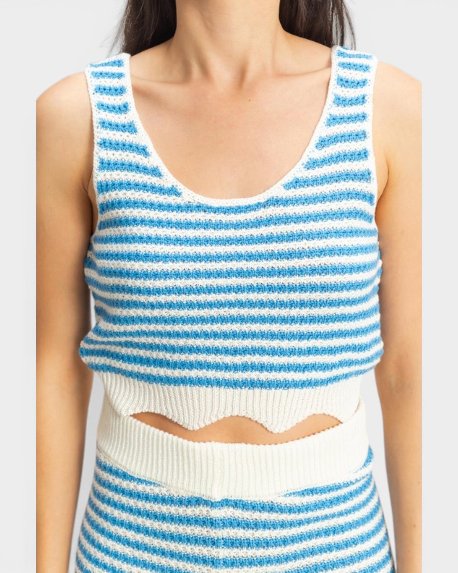 Blue and white striped sleeveless top on a plain background