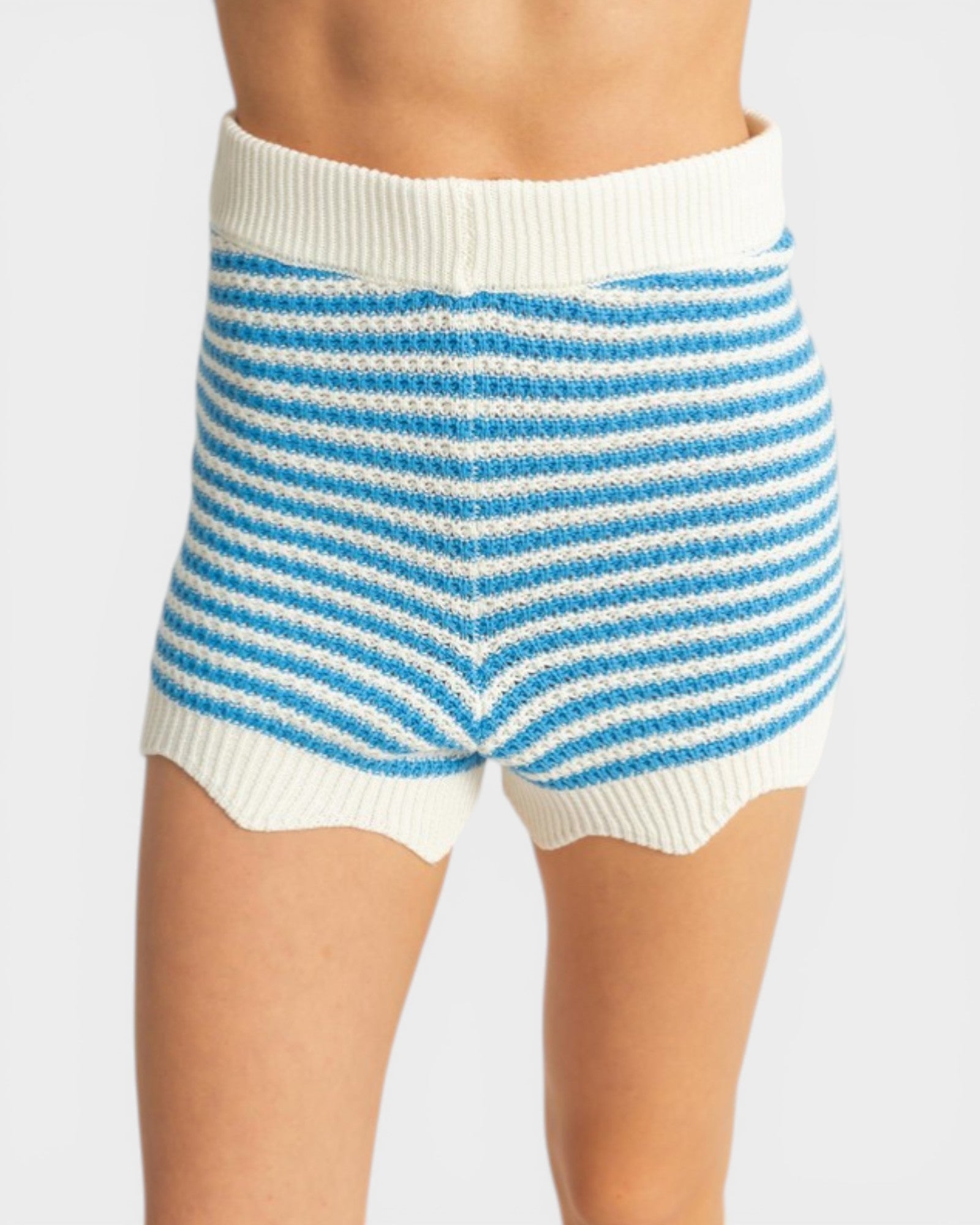 White and blue striped shorts on a plain background