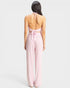 Pink jumpsuit worn by a model on a light gray background