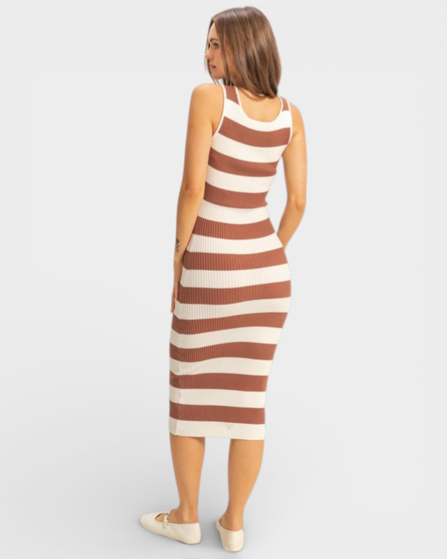 Woman wearing a brown and beige striped dress on a white background