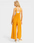 Woman wearing a yellow jumpsuit on a white background