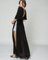 Woman wearing a black long dress with a white background