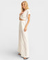 Woman wearing a white dress on a plain background