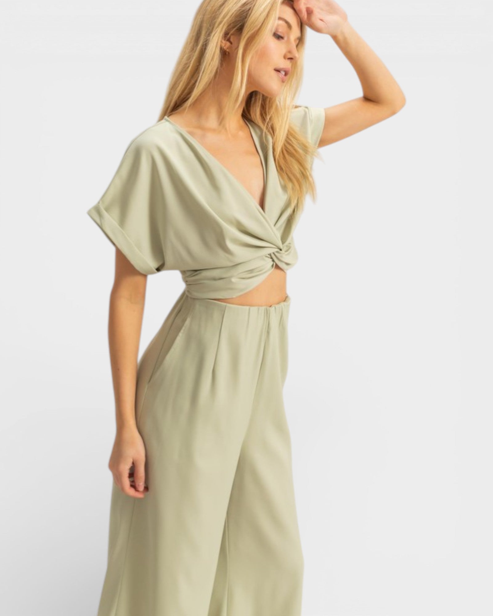 Woman wearing a light green dress with a white background