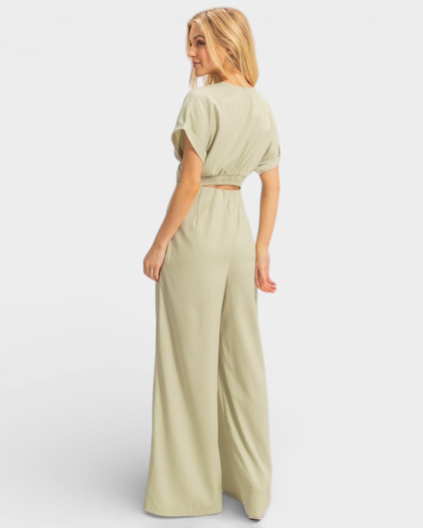 Woman wearing a light green outfit on a white background