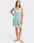 Woman wearing a light blue sleeveless dress on a white background