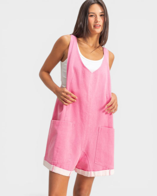 Woman wearing a pink sleeveless dress with a white background