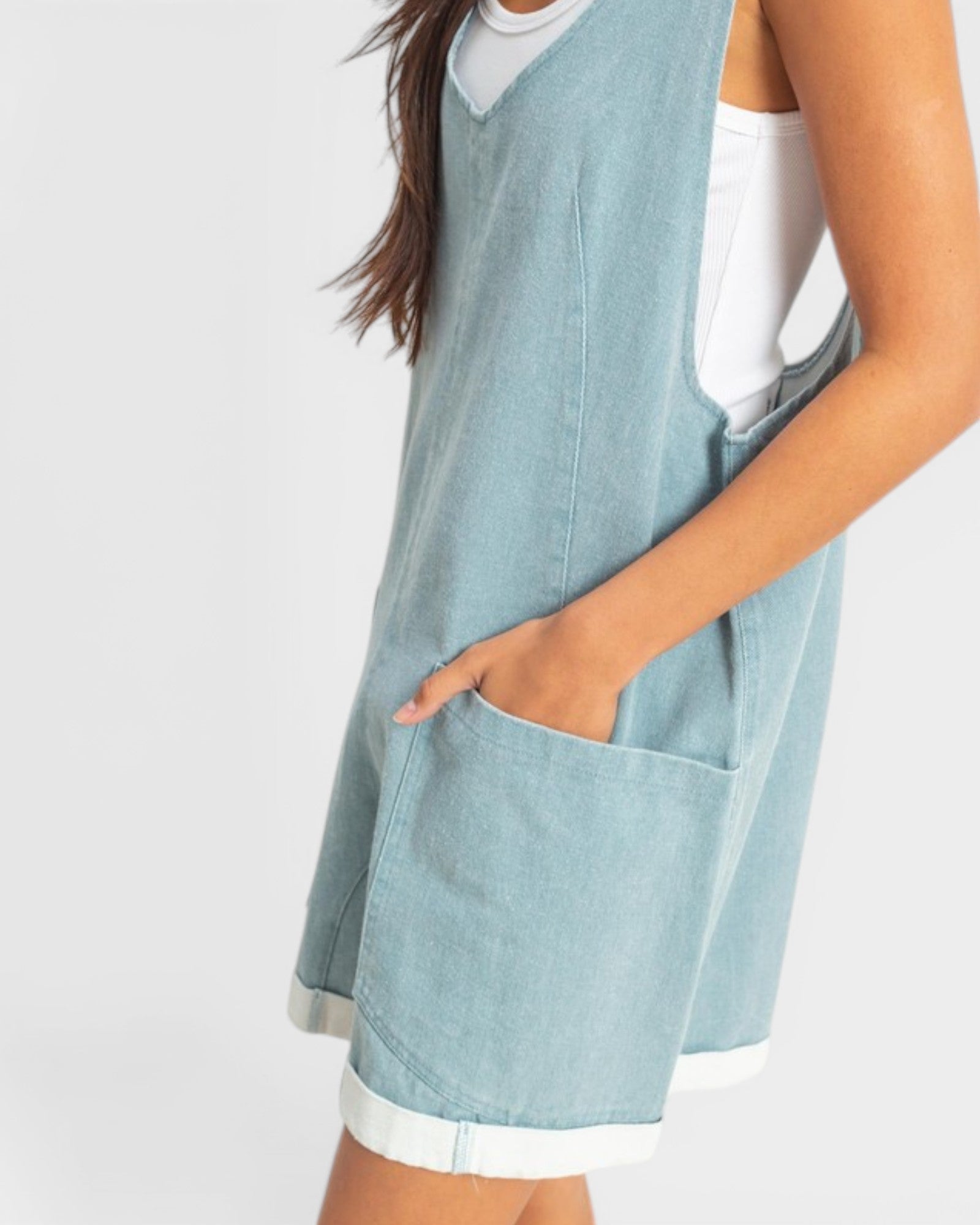 Light blue sleeveless dress worn by a person on a white background