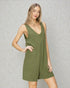 Woman wearing an olive green dress against a gray background