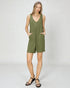 Woman wearing a green sleeveless dress on a white background