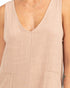 Beige sleeveless top worn by a person, with a close-up on the neckline and chest area.