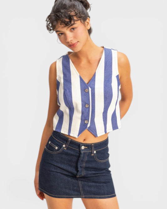 Woman wearing a blue and white striped sleeveless top with a denim skirt on a white background