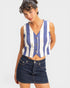 Woman wearing a blue and white striped sleeveless top with a denim skirt on a white background